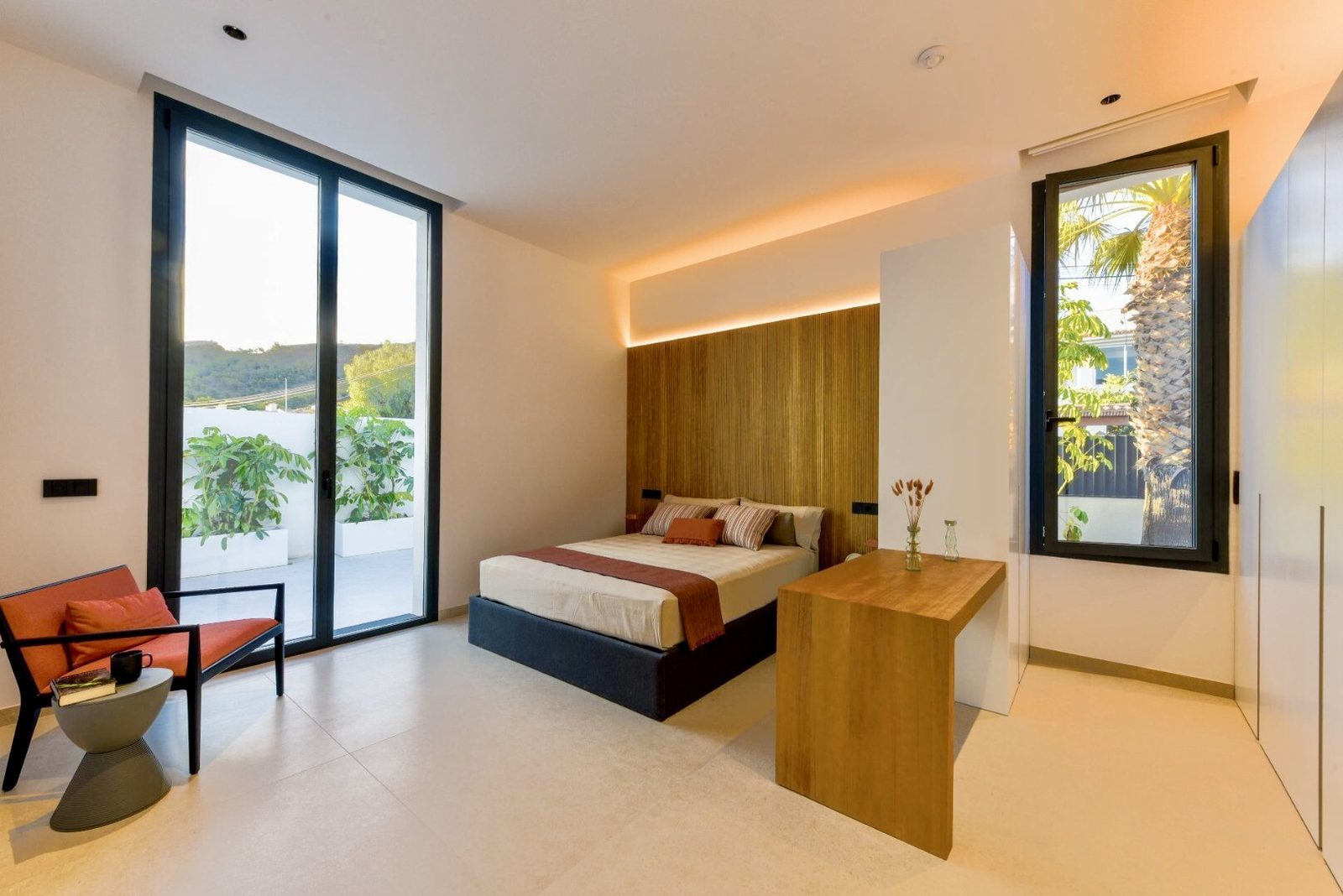 A bright bedroom with a view of lush greenery in a 4-bedroom villa in La Nucia - The Estates