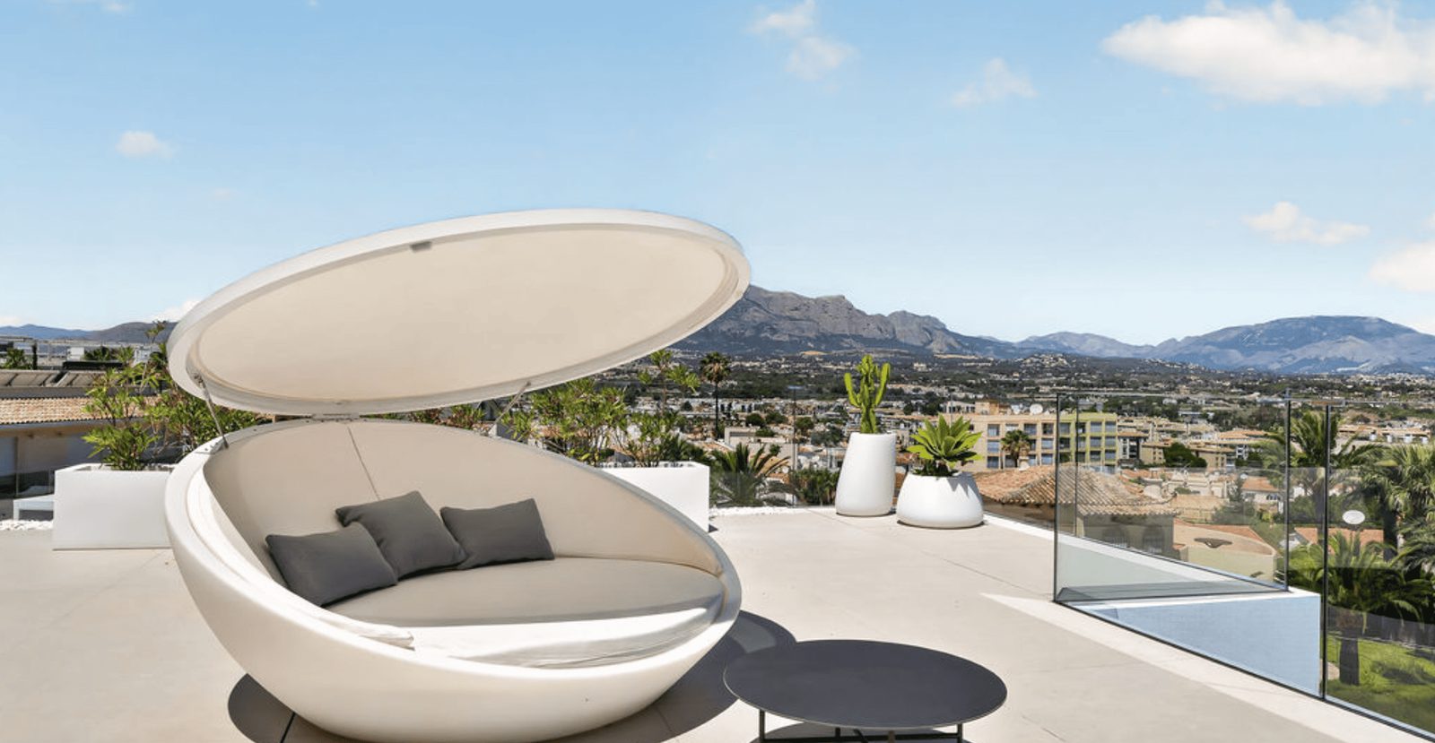 A stylish sun lounger with city and mountain views from a 4-bedroom villa in La Nucia - The Estates