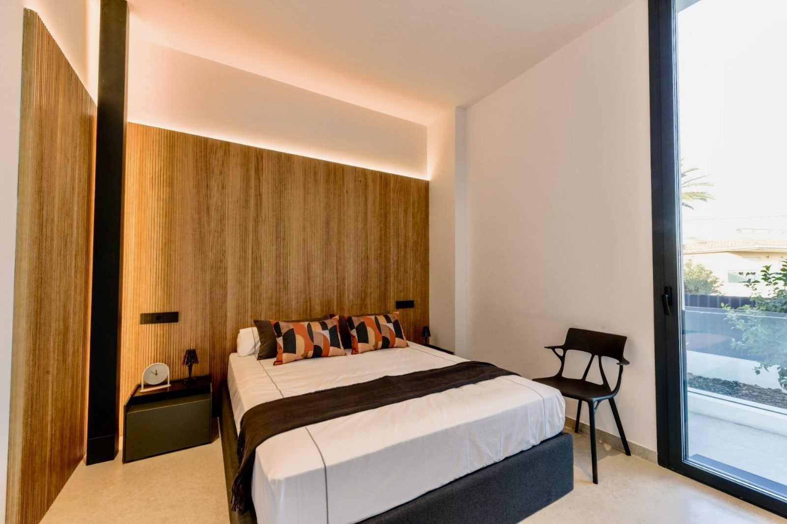 Stylish bedroom with wood accents and large windows in a 4-bedroom villa in La Nucia - The Estates