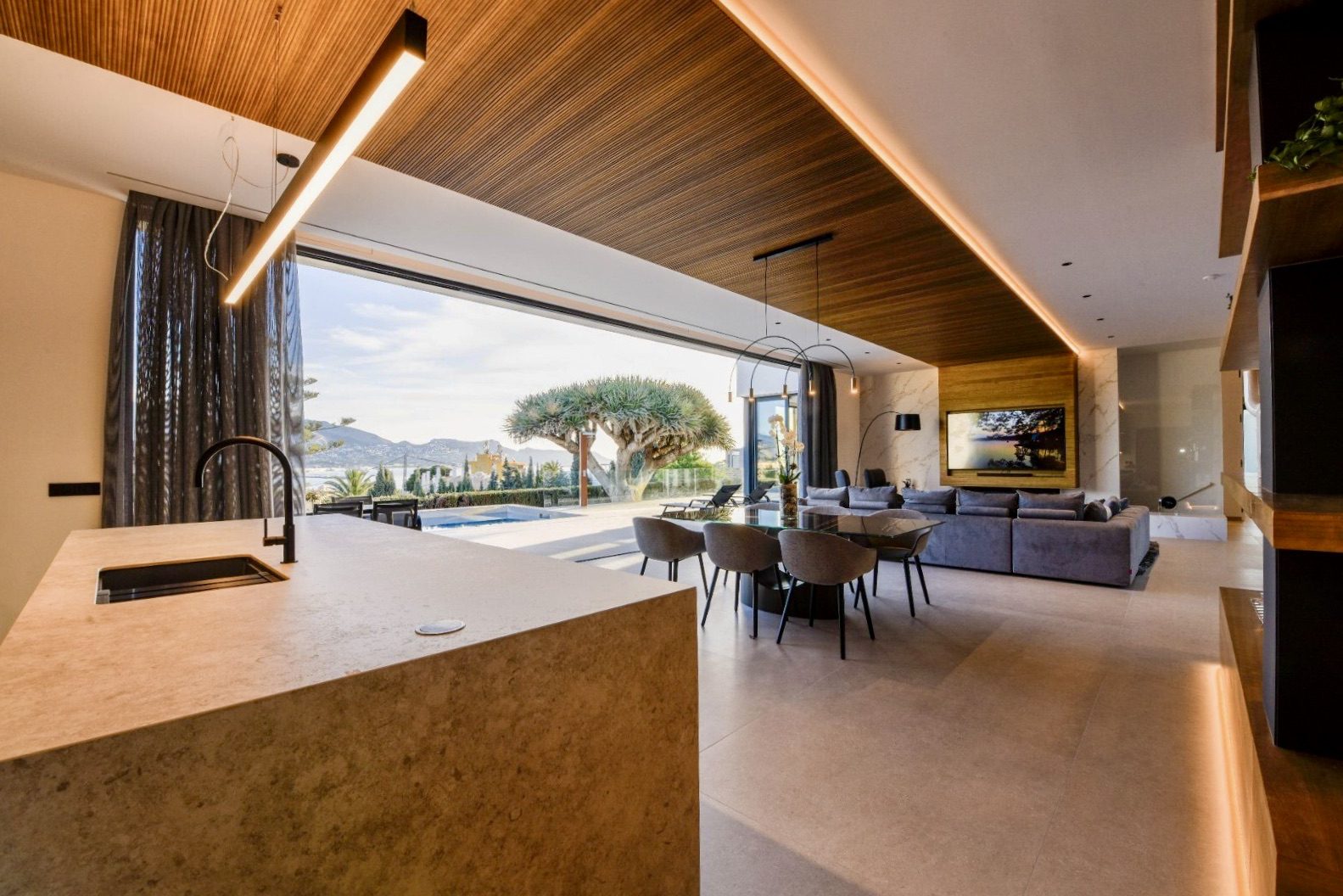 Stylish living room and kitchen with sea and city views in a 4-bedroom villa in La Nucia - The Estates