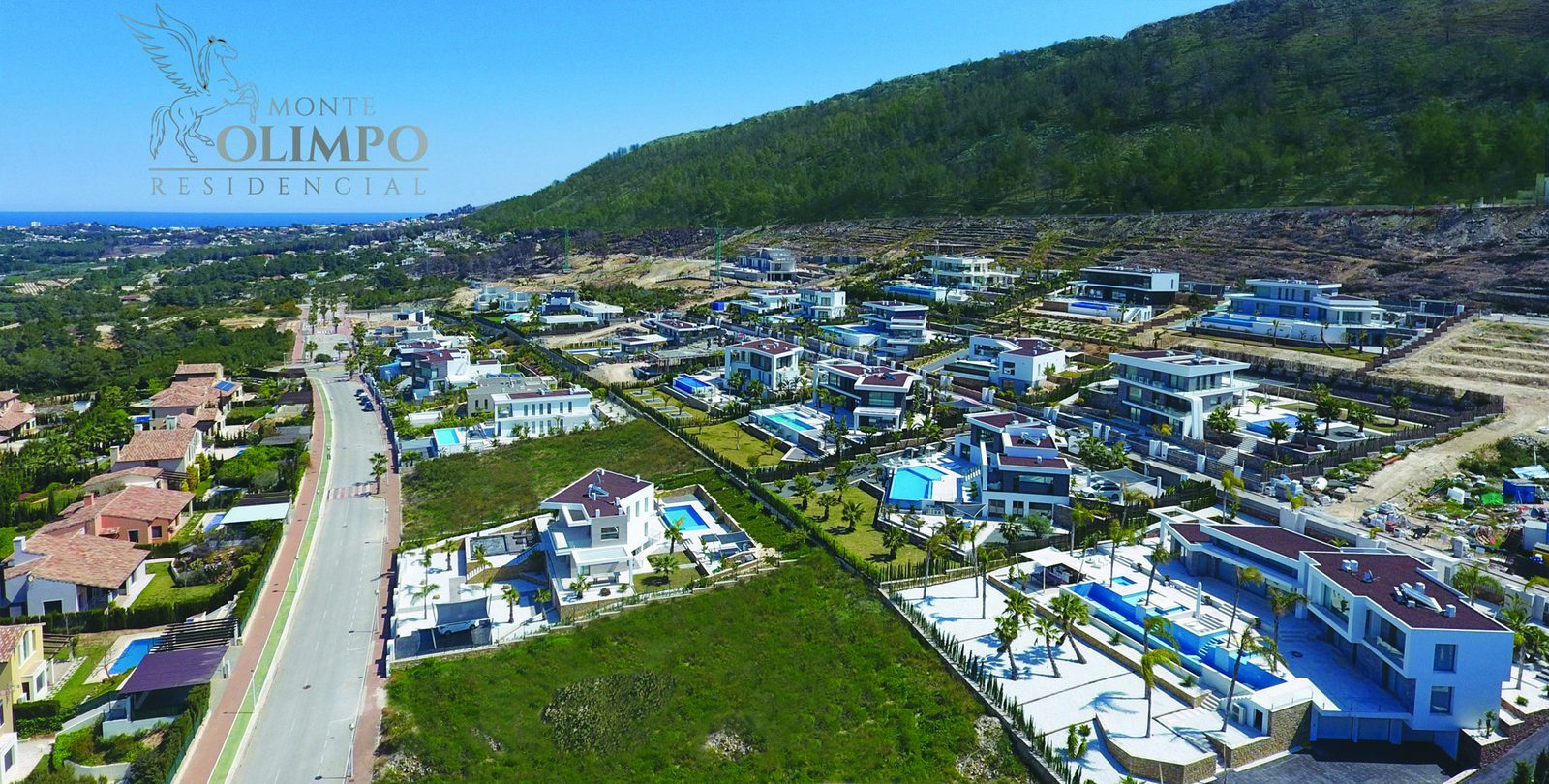 Aerial view of Monte Olimpo villas, pools, countryside, sea and mountain views of a