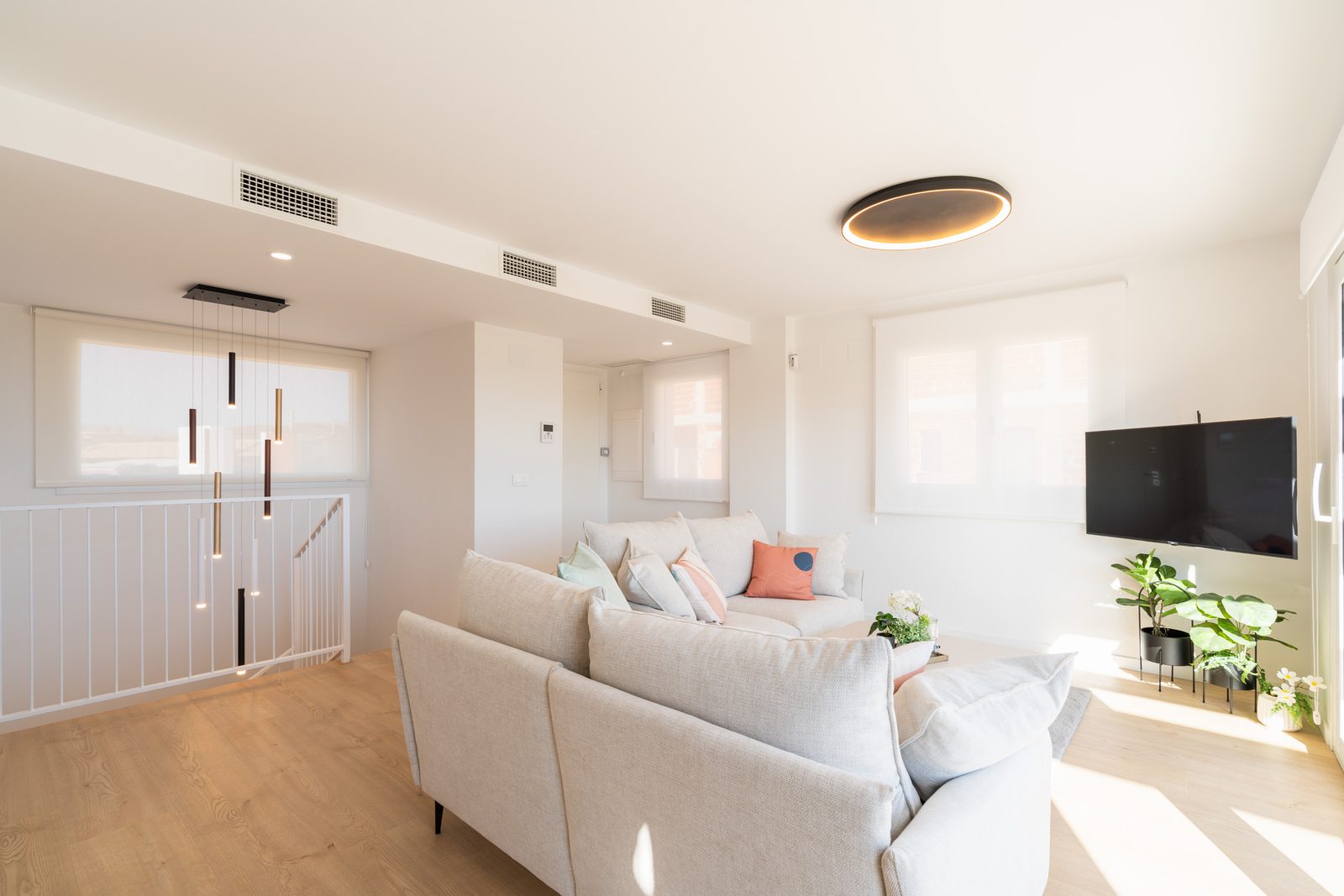 A bright living room with modern decor and city views in a 4-bedroom townhouse in La Nucía - The Estates
