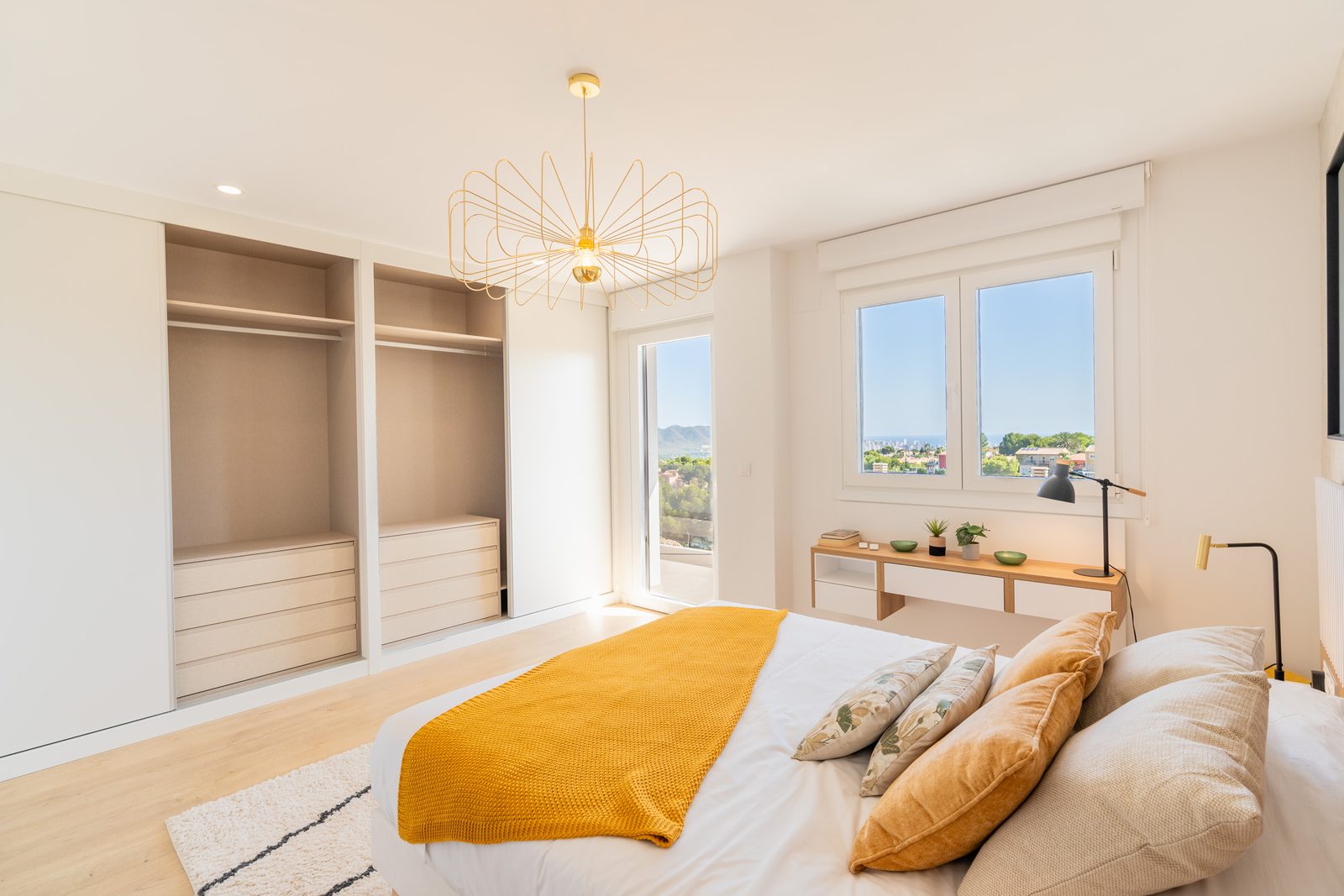 A bright bedroom with built-in wardrobes and views of the city in a 4-bedroom townhouse in La Nucía - The Estates