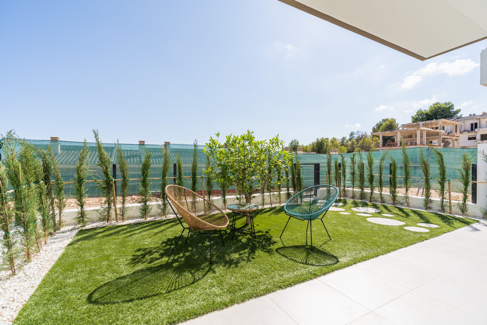 A furnished terrace with a view of greenery surrounding a 4-bedroom townhouse in La Nucía - The Estates