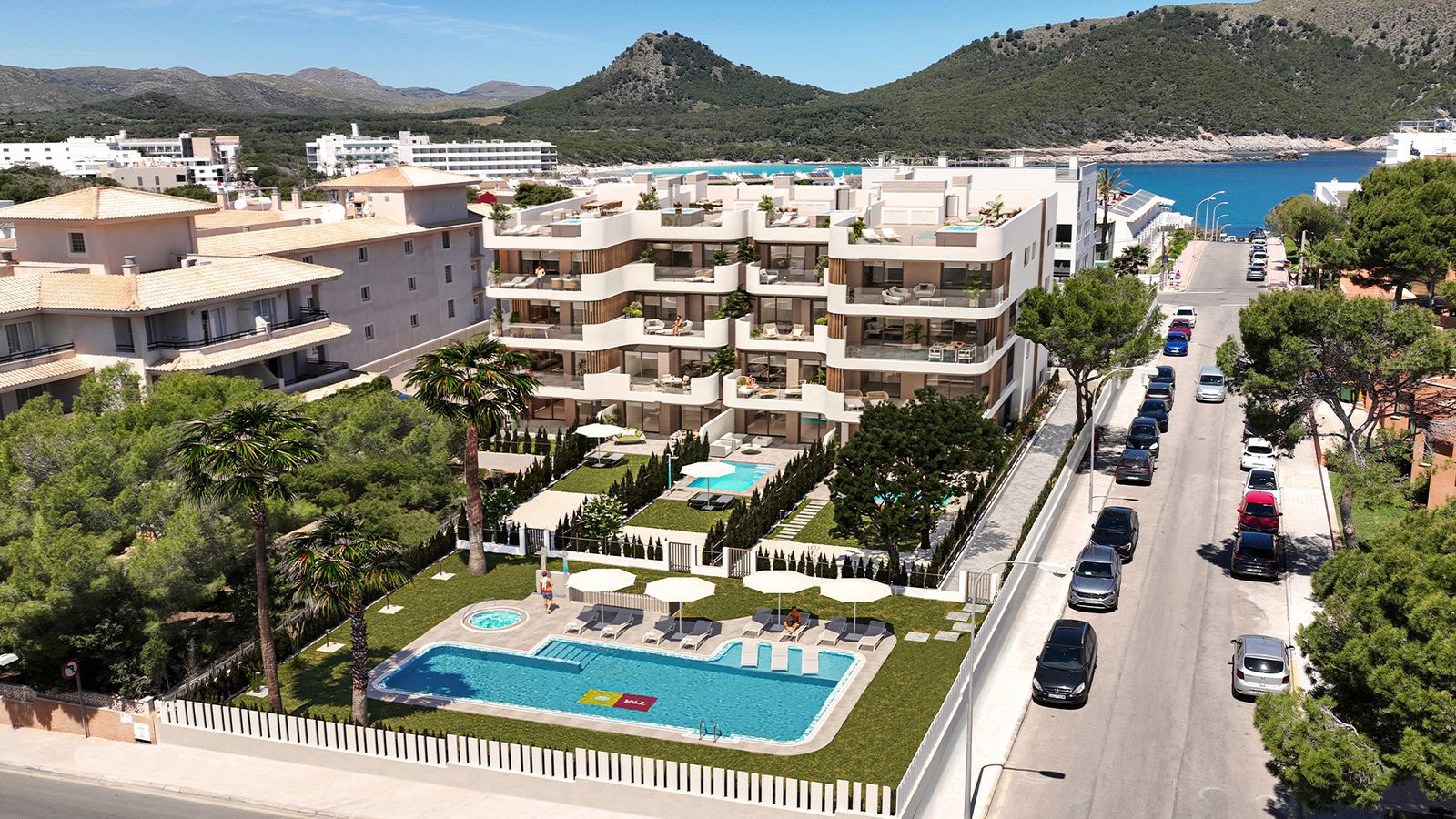 Aerial view of apartment complex with pools, bay and mountains, a 2-bedroom apartment in Capdepera - The Estates