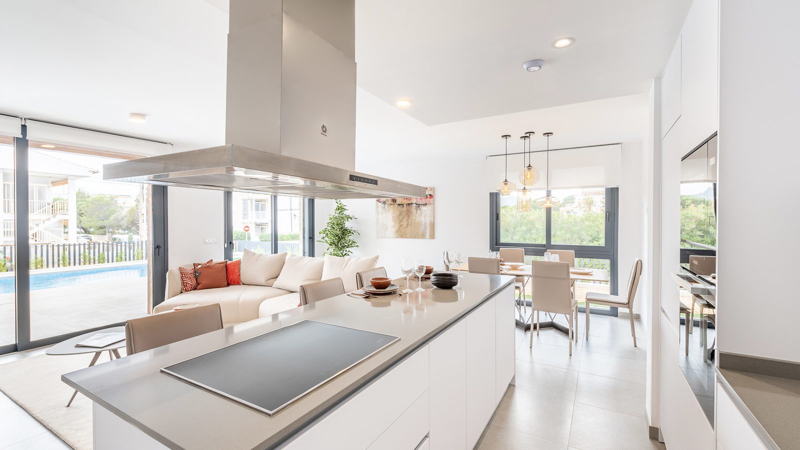 Modern kitchen and living area with pool view in a 3-bedroom semi-detached in Capdepera - The Estates