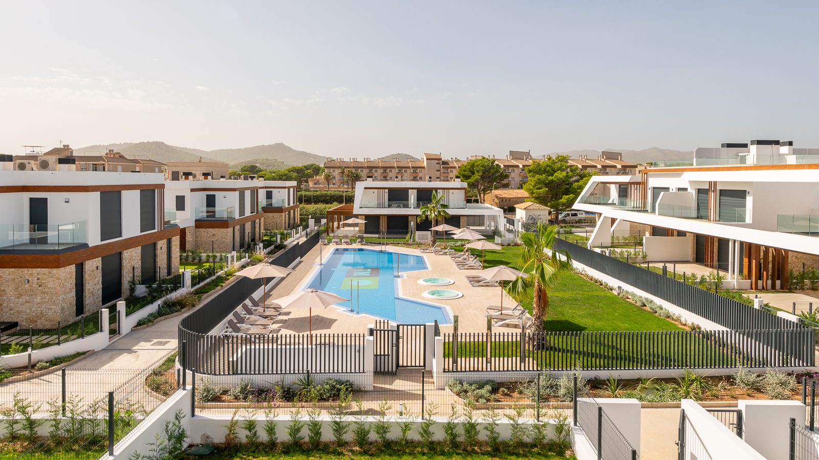A view of the communal pool and gardens of a 3-bedroom semi-detached in Capdepera - The Estates