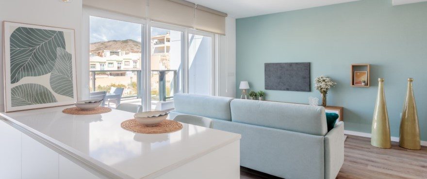 Bright open-plan kitchen and living room with balcony views of a 4-bedroom villa in Finestrat - The Estates
