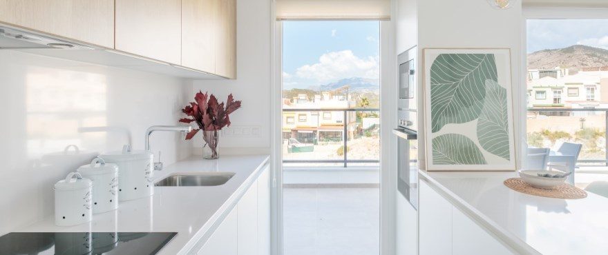 Bright modern kitchen and dining area with mountain views of a 4-bedroom villa in Finestrat - The Estates