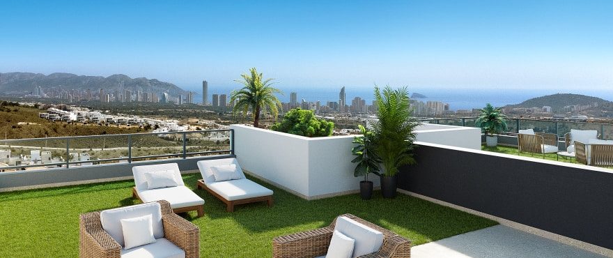 Rooftop terrace with sun loungers, seating, palms and panoramic Benidorm skyline views at a 4-bedroom villa in Finestrat - The Estates