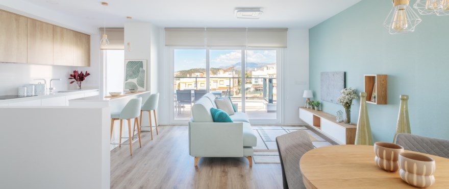 Open-plan kitchen, living and dining area with balcony views of a 4-bedroom villa in Finestrat - The Estates