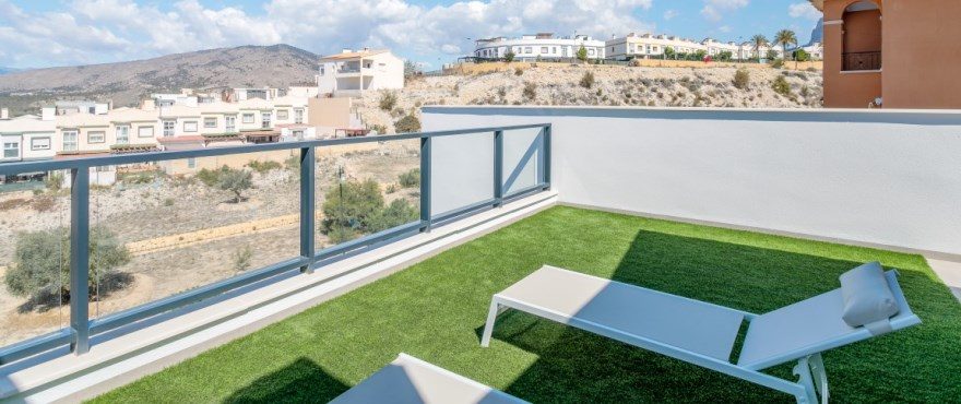 Rooftop terrace with loungers and mountain views at a 4-bedroom villa in Finestrat - The Estates