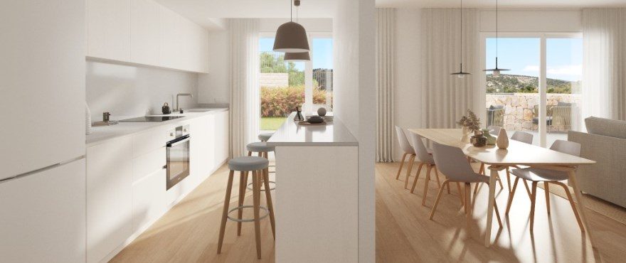 Open-plan white kitchen and dining area with garden views in a 4-bedroom villa in Finestrat - The Estates