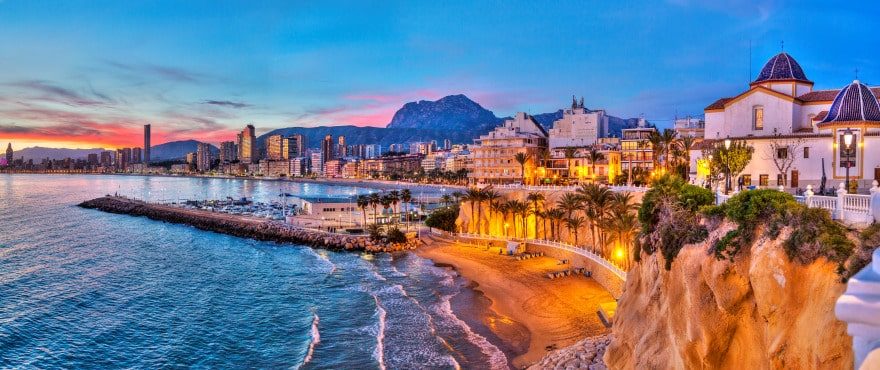 Panoramic Benidorm coastline with beach, marina and illuminated waterfront at dusk, viewed from a 4-bedroom villa in Finestrat - The Estates