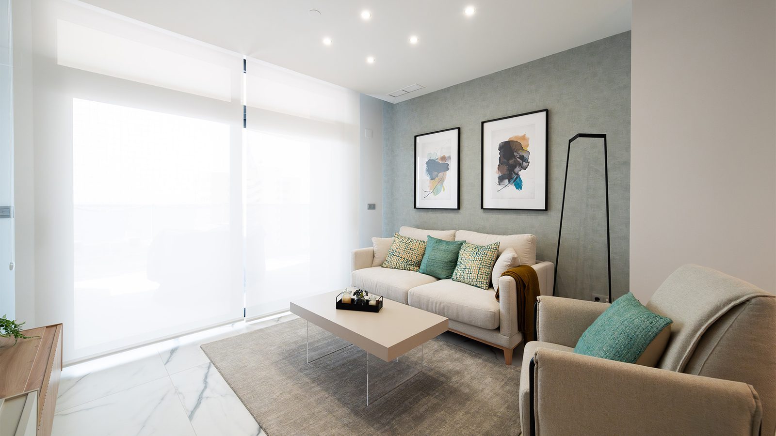 Modern living room with sofa, armchair, coffee table and sea-view windows in a 3-bedroom apartment in Benidorm - The Estates