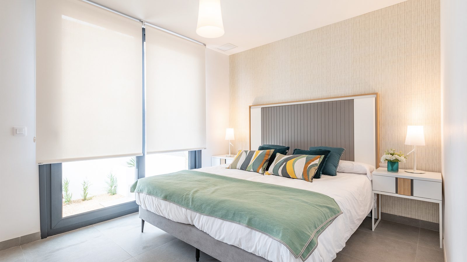 A bright bedroom with a large window in a 3-bedroom semi-detached in Capdepera - The Estates