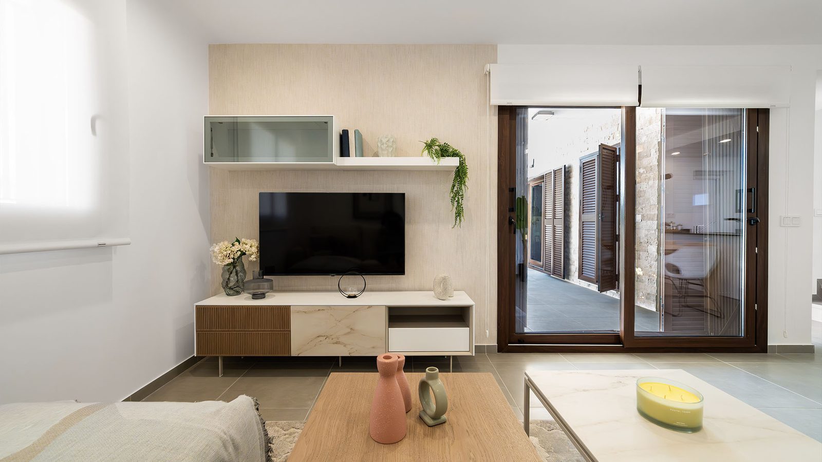 Modern living room with TV unit, shelving and patio doors of a 2-bedroom semi-detached in Pulpí - The Estates