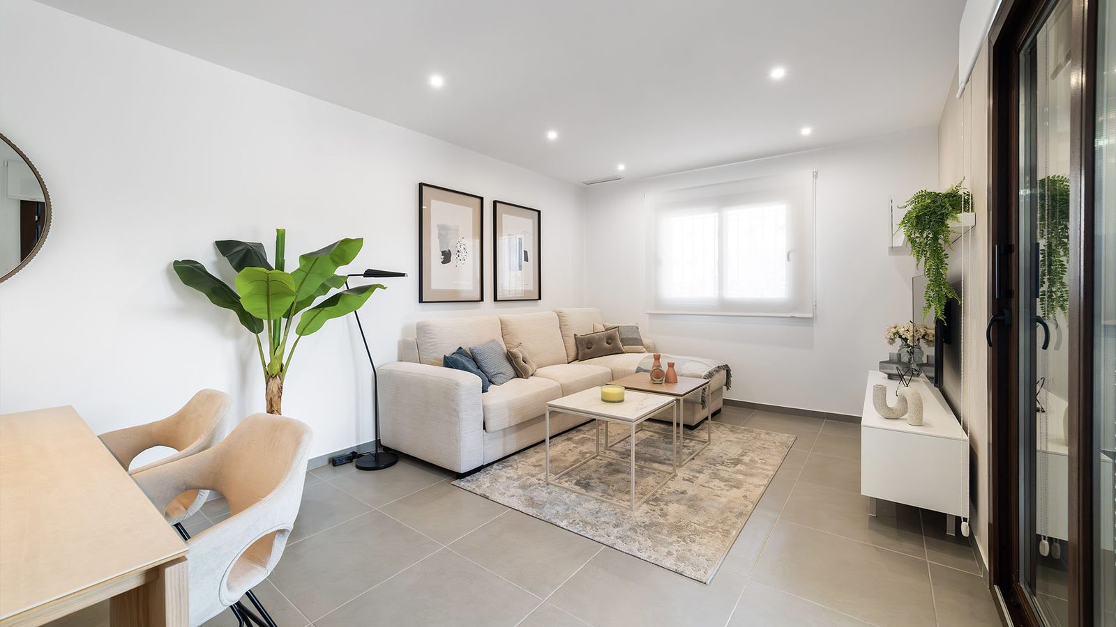 Bright open-plan living and dining room with sofa, coffee tables and large windows in a 2-bedroom semi-detached in Pulpí - The Estates