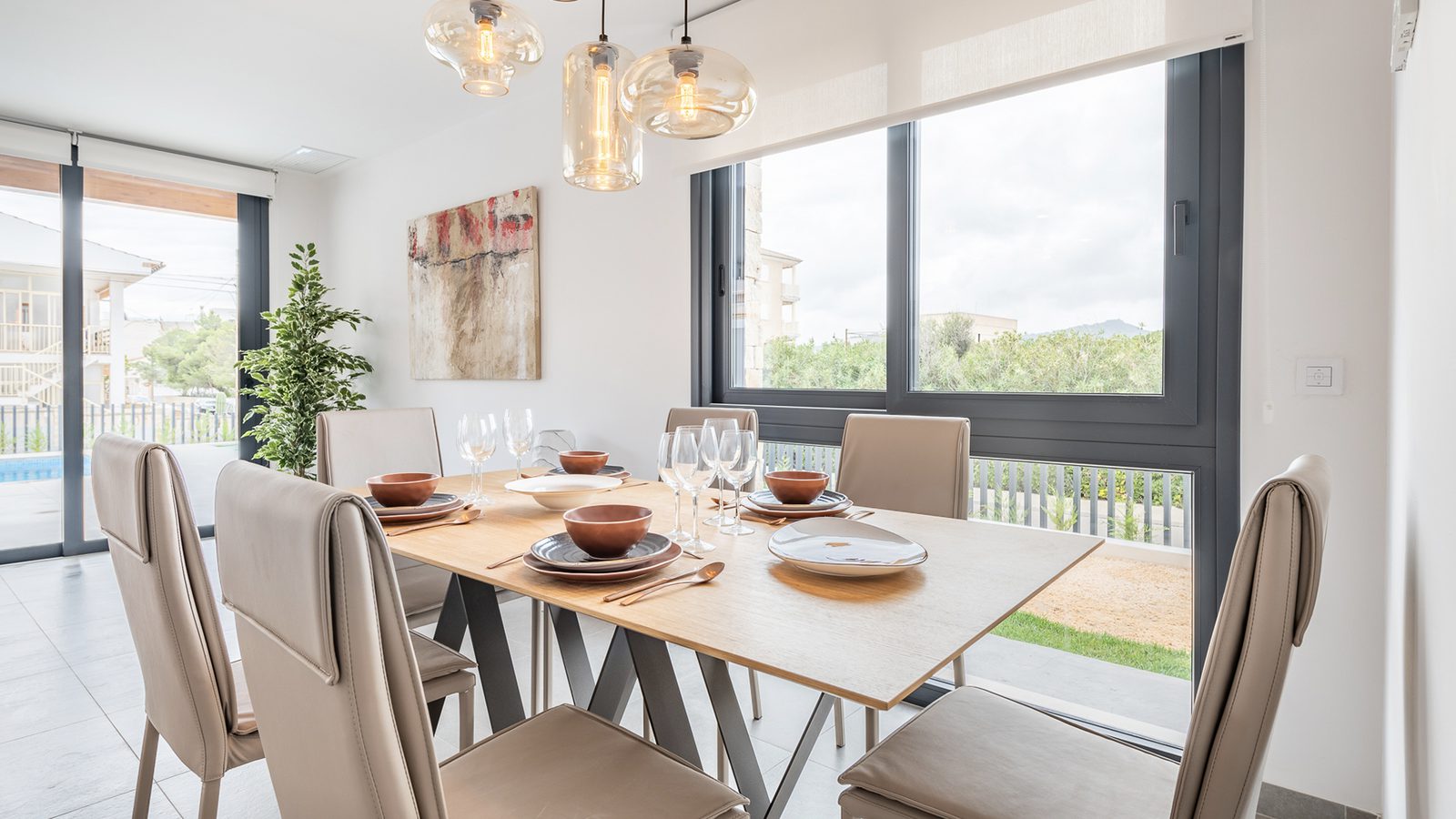 Stylish dining area with modern lighting and artwork in a 3-bedroom semi-detached in Capdepera - The Estates