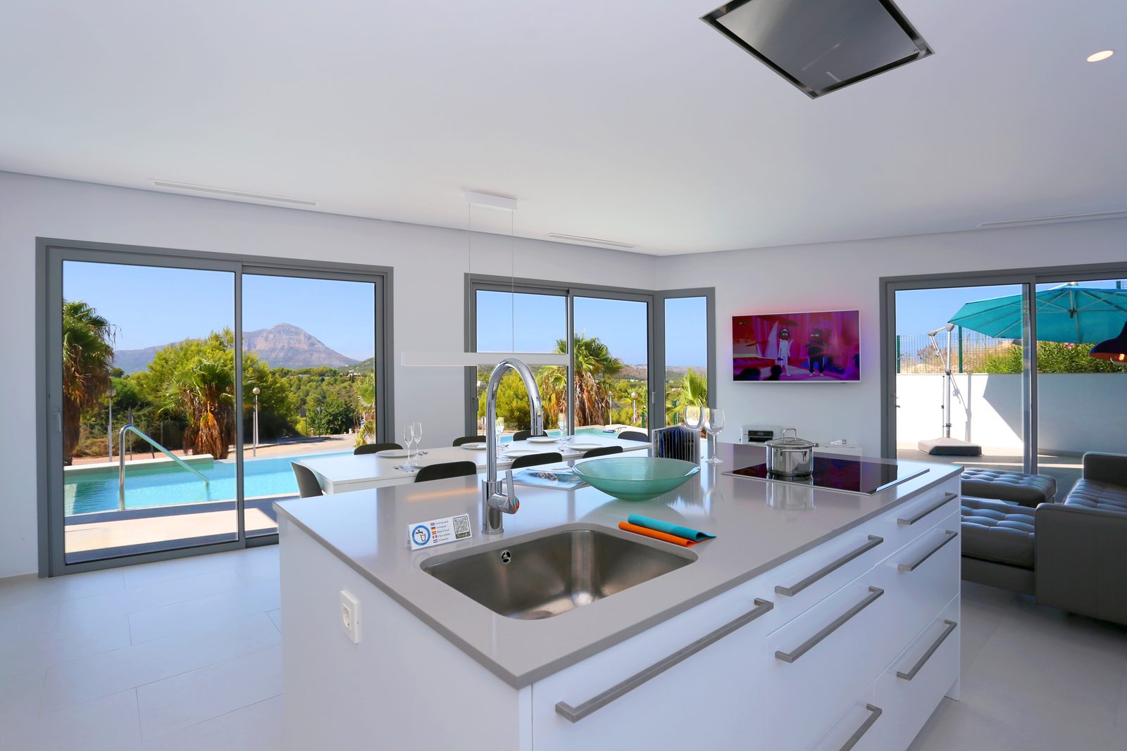 Modern kitchen with island and stunning sea views inside a 4-bedroom chalet in Javea - The Estates