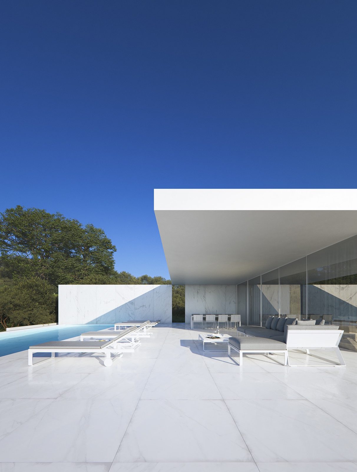 Modern villa pool area with sun loungers and mountain views of a 5-bedroom villa in Moraira - The Estates