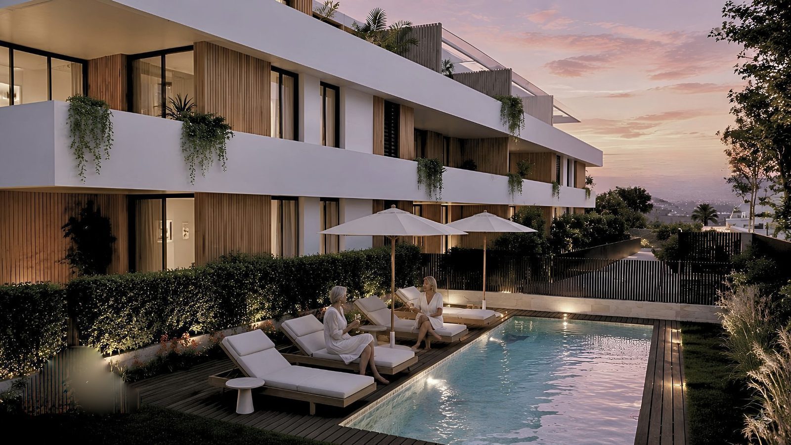 Exterior view of a 2-bedroom apartment with a pool and lounge area in Jávea - The Estates