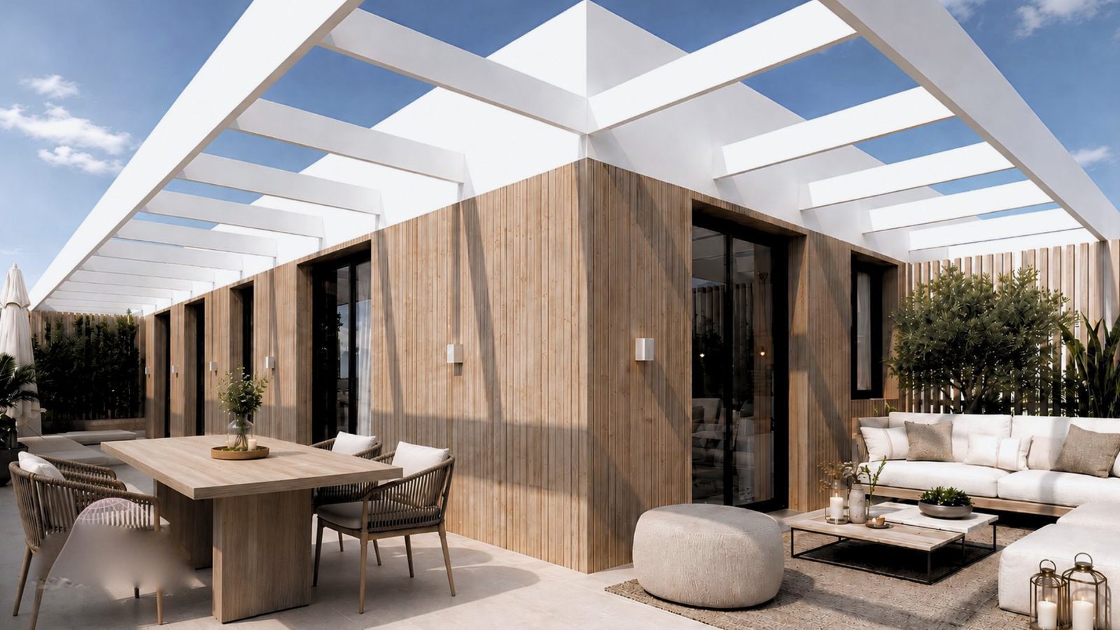 A modern terrace with seating and a dining area on a 2-bedroom apartment in Jávea - The Estates