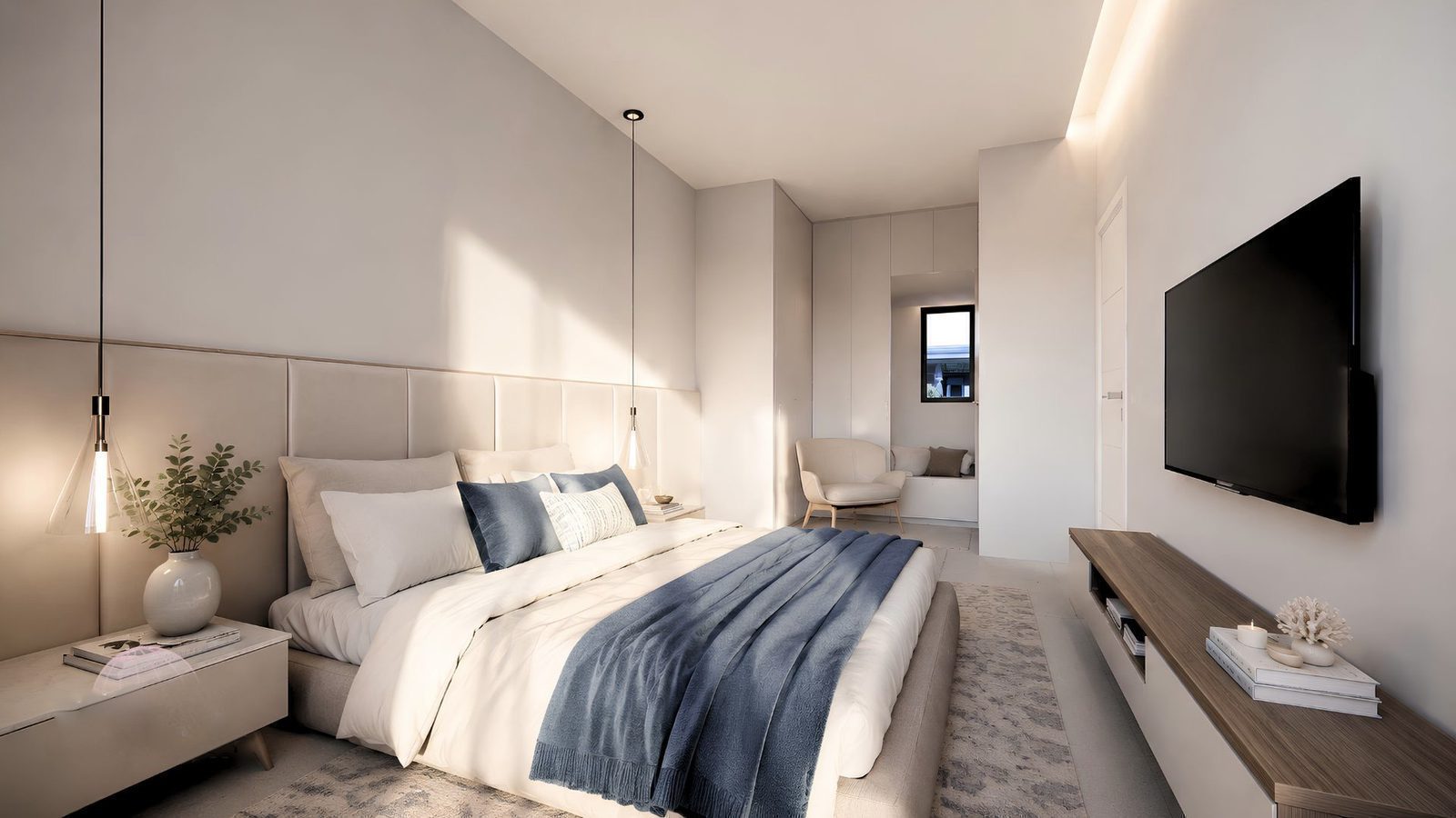 A modern bedroom with a large TV and window view of a garden in a 2-bedroom apartment in Jávea - The Estates