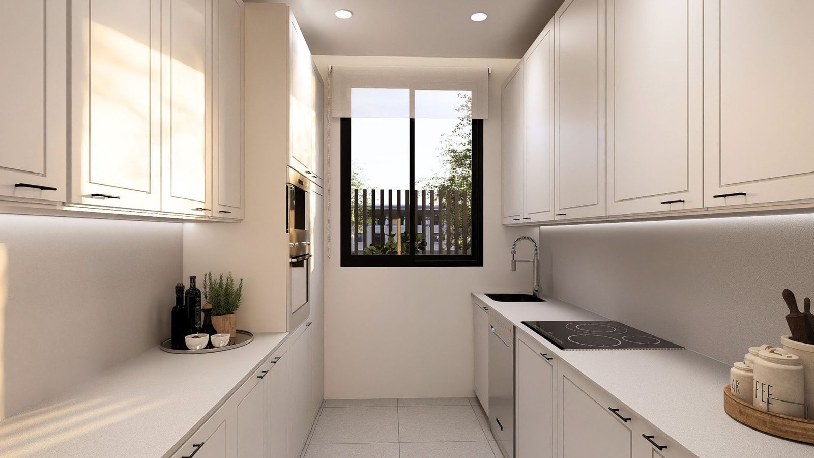 A modern kitchen with white cabinetry and a window overlooking a garden in a 2-bedroom apartment in Jávea - The Estates