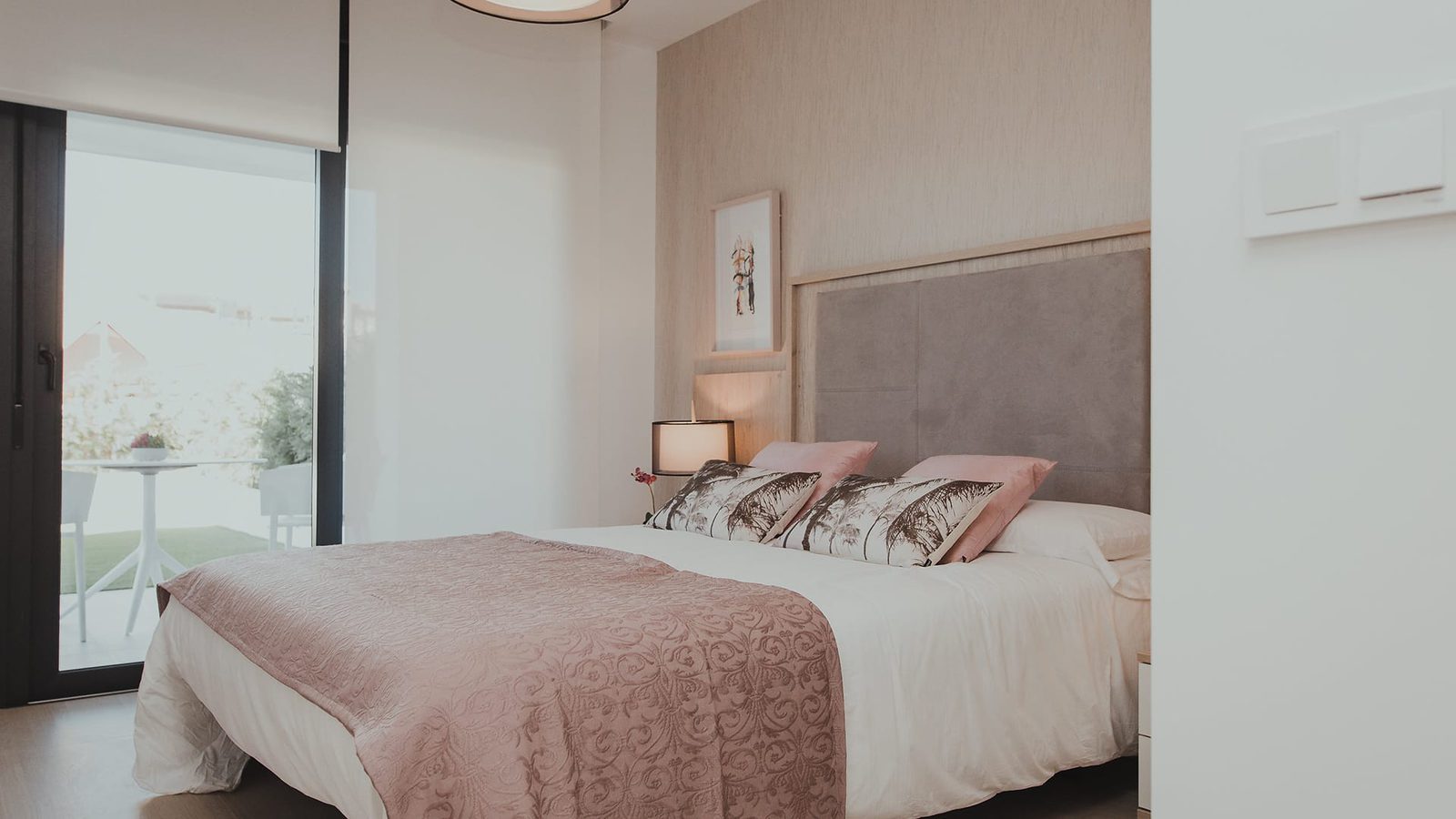 A stylish bedroom with a view in a 2-bedroom apartment in Estepona - The Estates