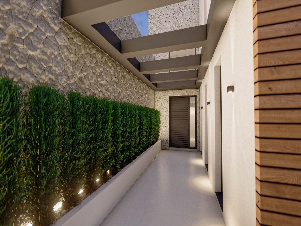 Covered entrance walkway with stone wall, planted hedge and timber cladding of a 4-bedroom villa in Altea - The Estates