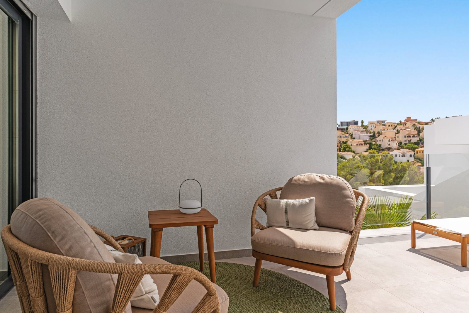 Relaxing outdoor seating area with views of a townscape from a 3-bedroom apartment in Benitachell - The Estates
