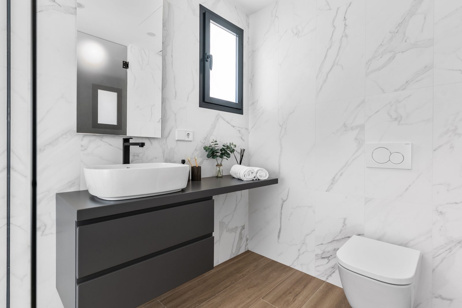 A modern bathroom with marble tiling and sleek fixtures in a 3-bedroom apartment in Benitachell - The Estates