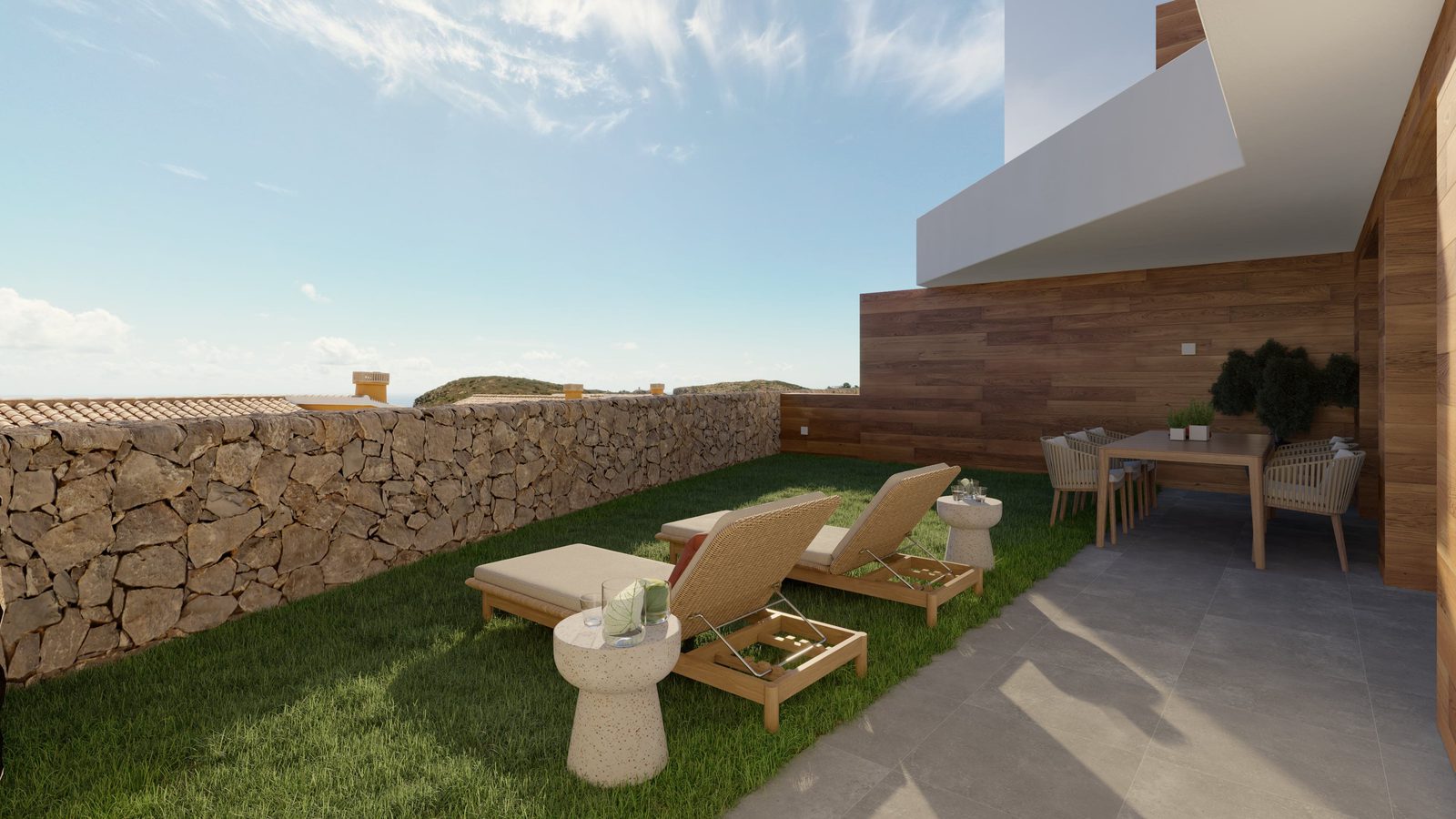 A sunny terrace with lounge chairs and dining area of a 3-bedroom apartment in Benitachell - The Estates