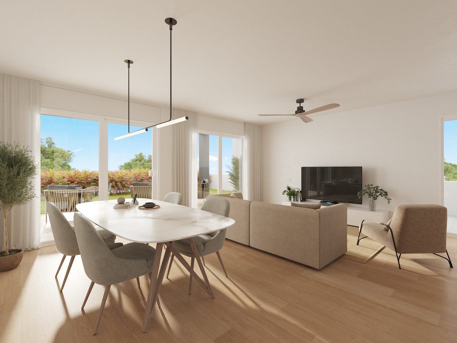 A bright living and dining area with garden views in a 3-bedroom townhouse in Finestrat - The Estates