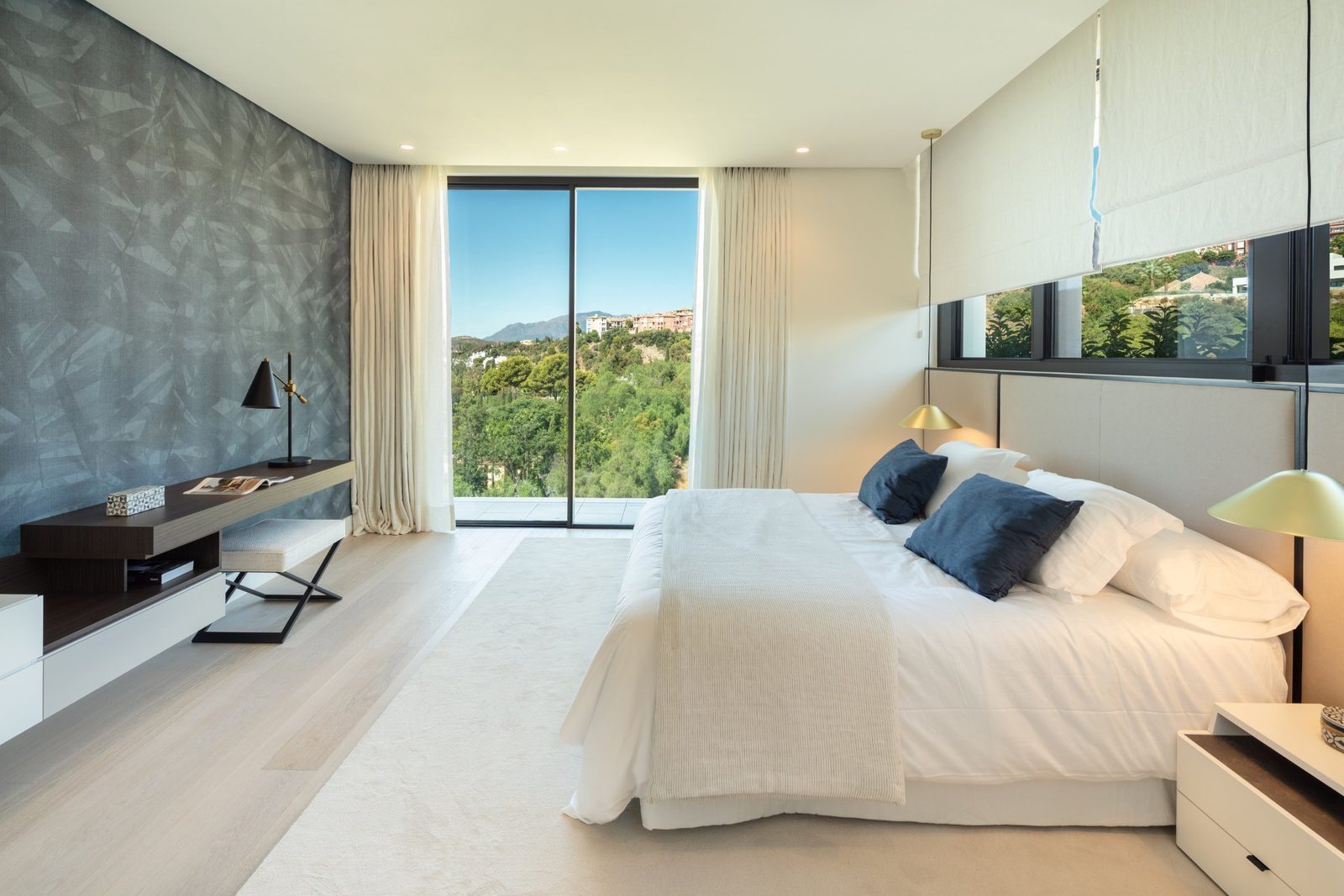 Modern bedroom with panoramic hillside views in a 7-bedroom villa in Málaga - The Estates