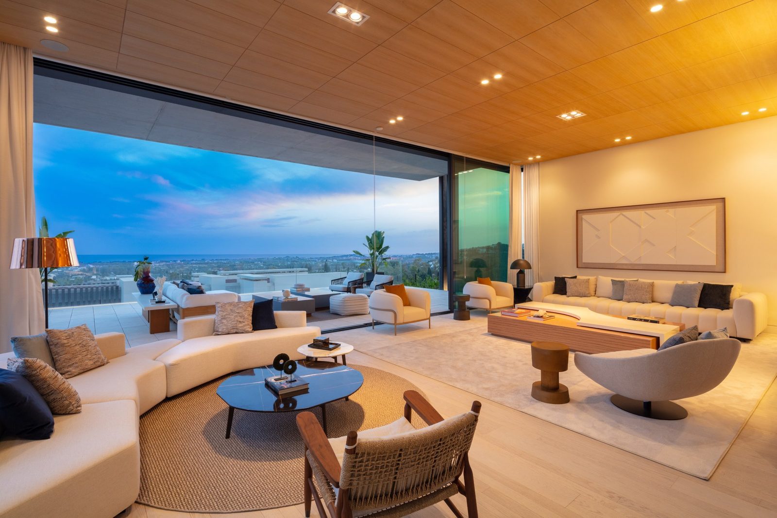 Contemporary living room with panoramic sea views in a 7-bedroom villa in Málaga - The Estates