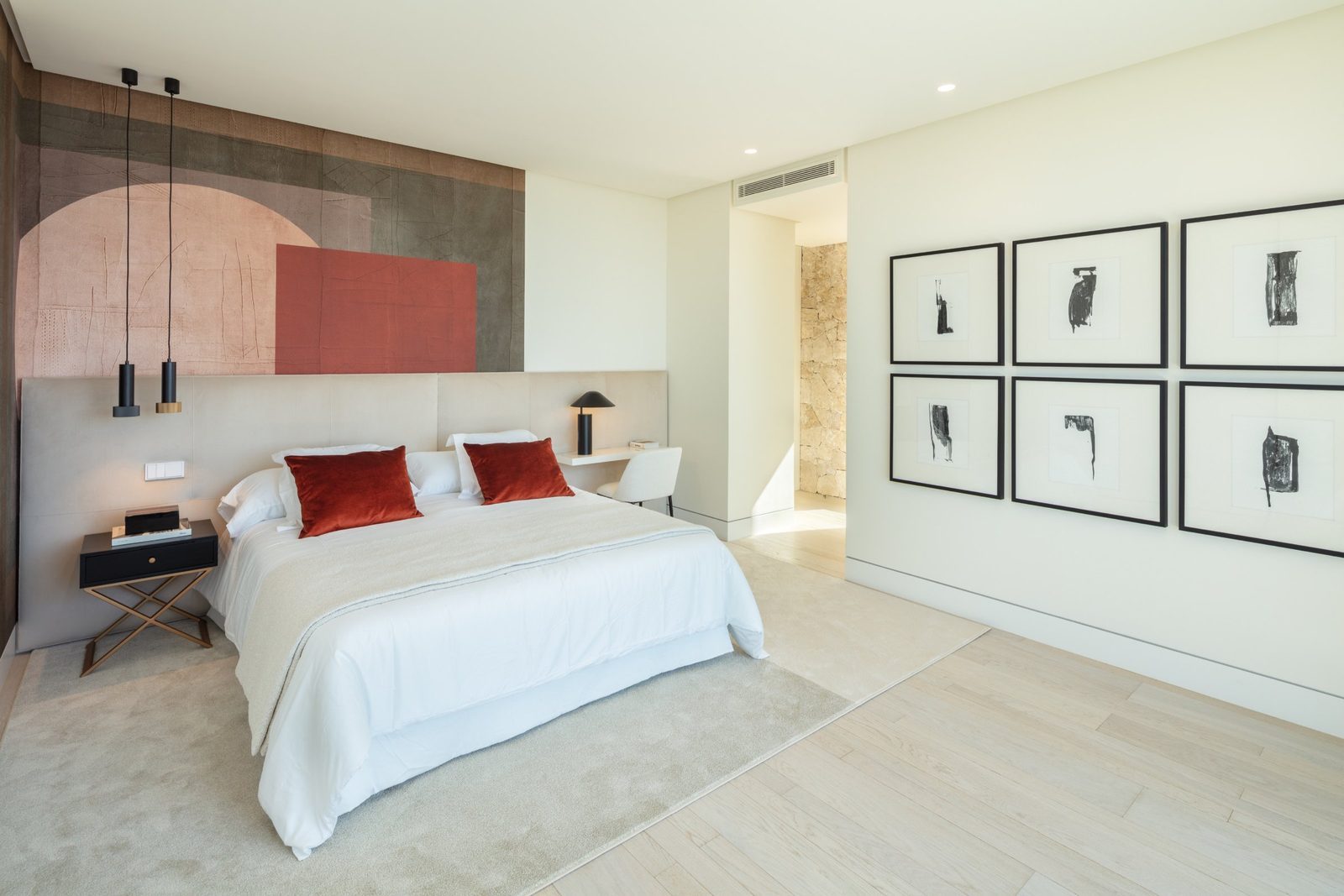 Contemporary bedroom with a double bed, abstract artwork and pendant lights in a 7-bedroom villa in Málaga - The Estates