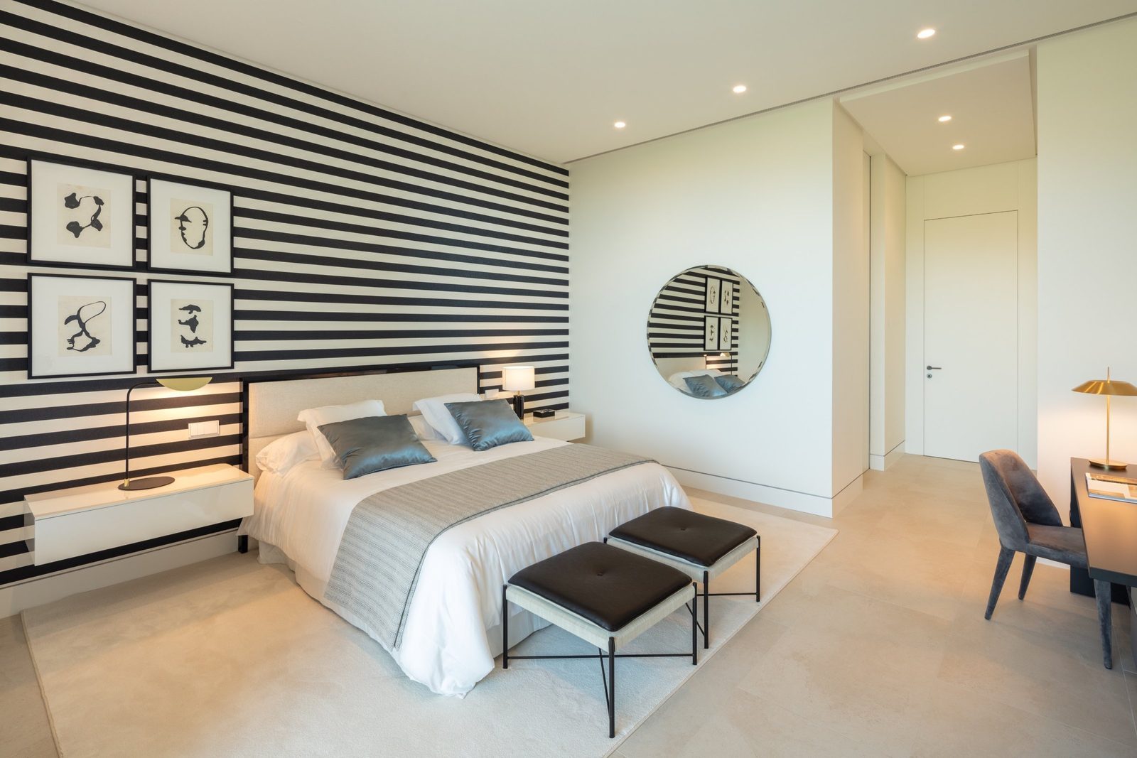 Contemporary bedroom with striped feature wall, double bed, bedside tables and dressing desk in a 7-bedroom villa in Málaga - The Estates