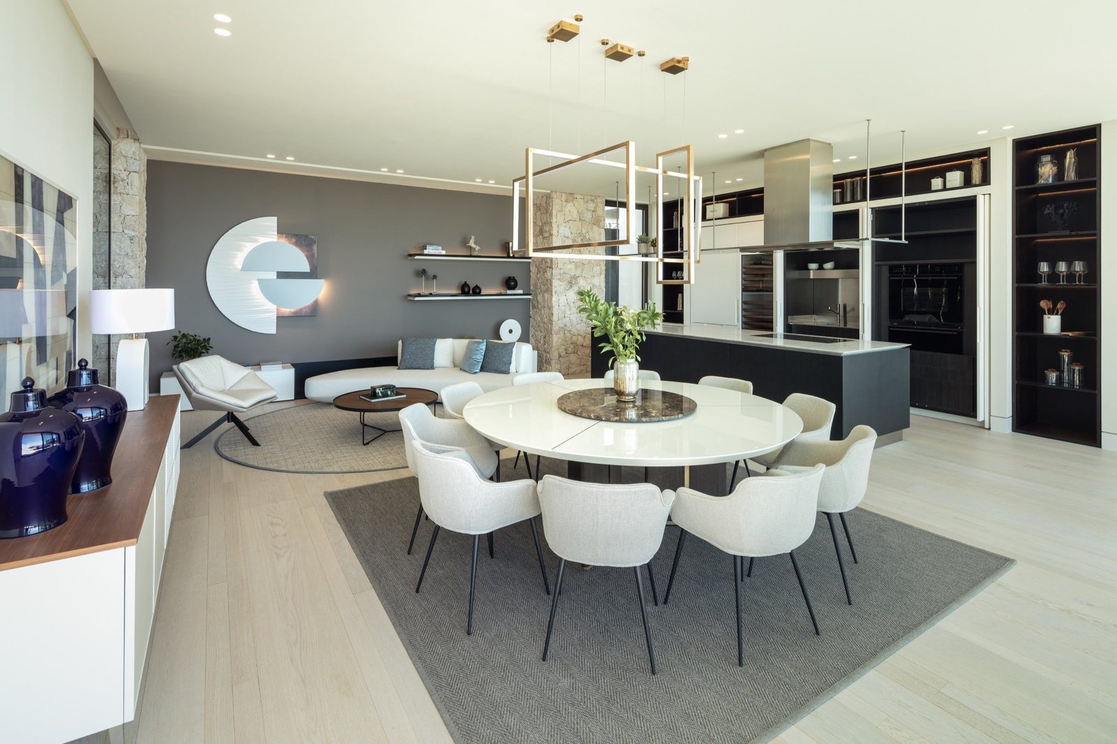 Modern open-plan living, dining and kitchen area of a 7-bedroom villa in Málaga - The Estates