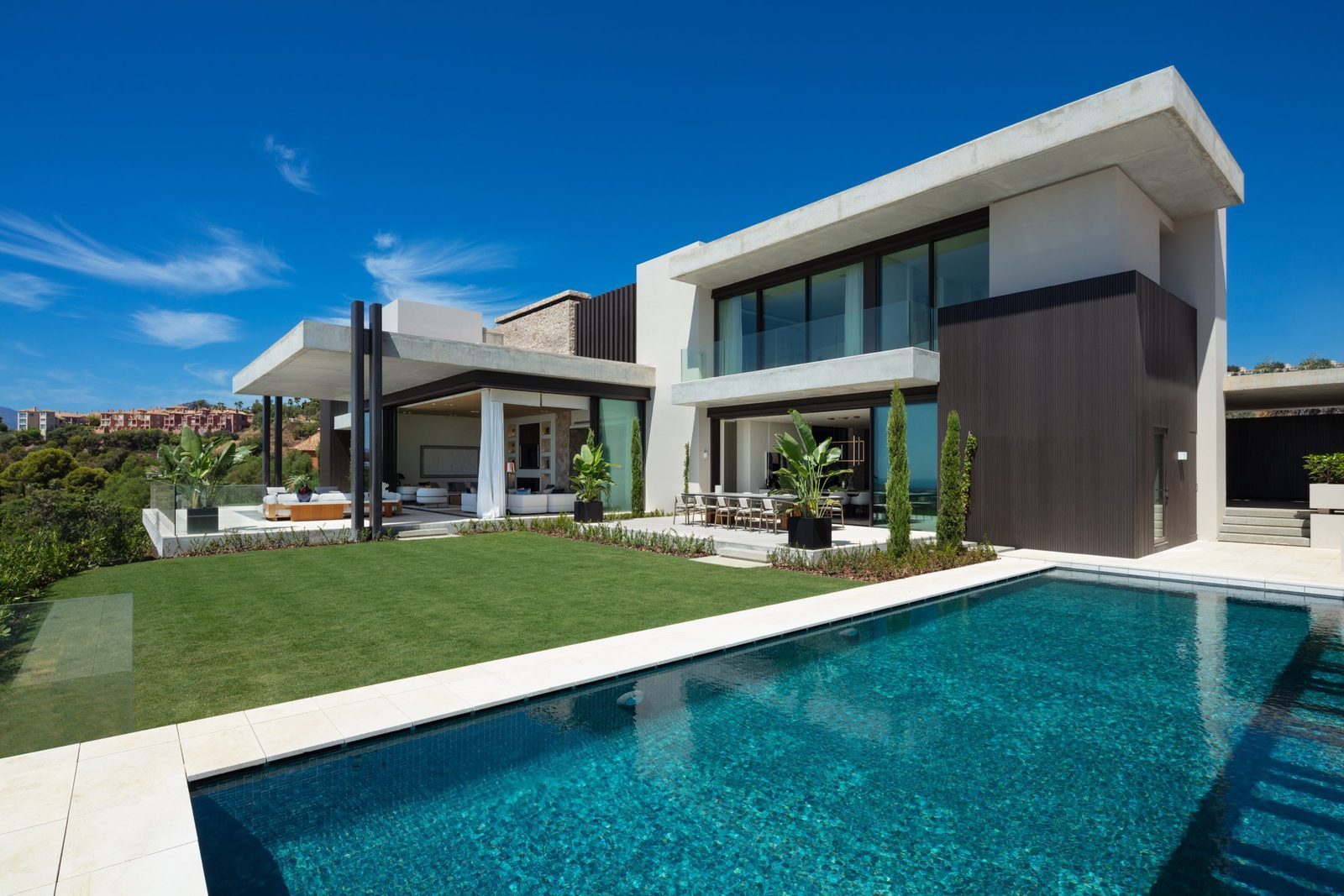 Modern villa exterior with swimming pool, garden and sea views