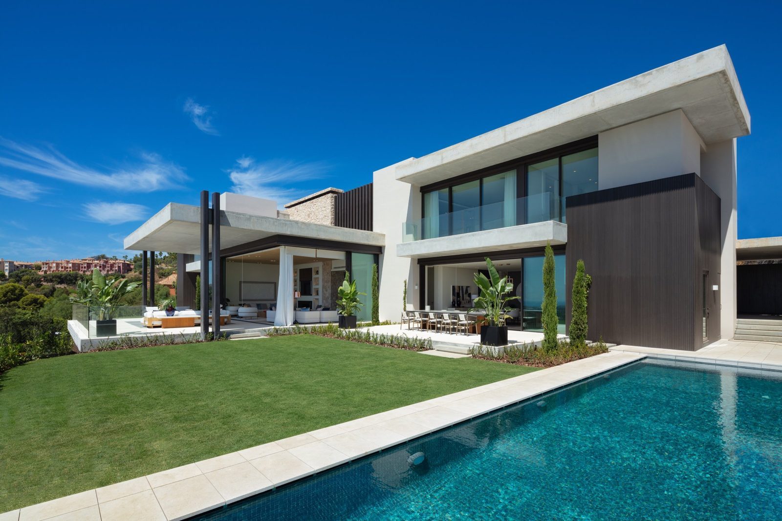Modern villa exterior with pool, lawn and terraces of a 7-bedroom villa in Málaga - The Estates