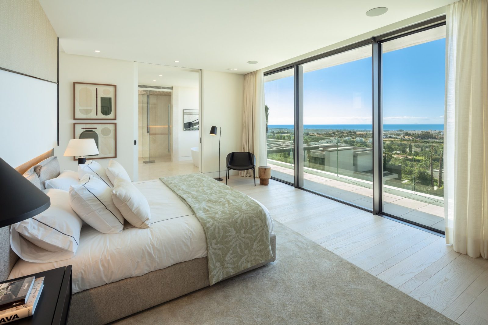 Bright bedroom with floor-to-ceiling windows and panoramic sea views in a 7-bedroom villa in Málaga - The Estates