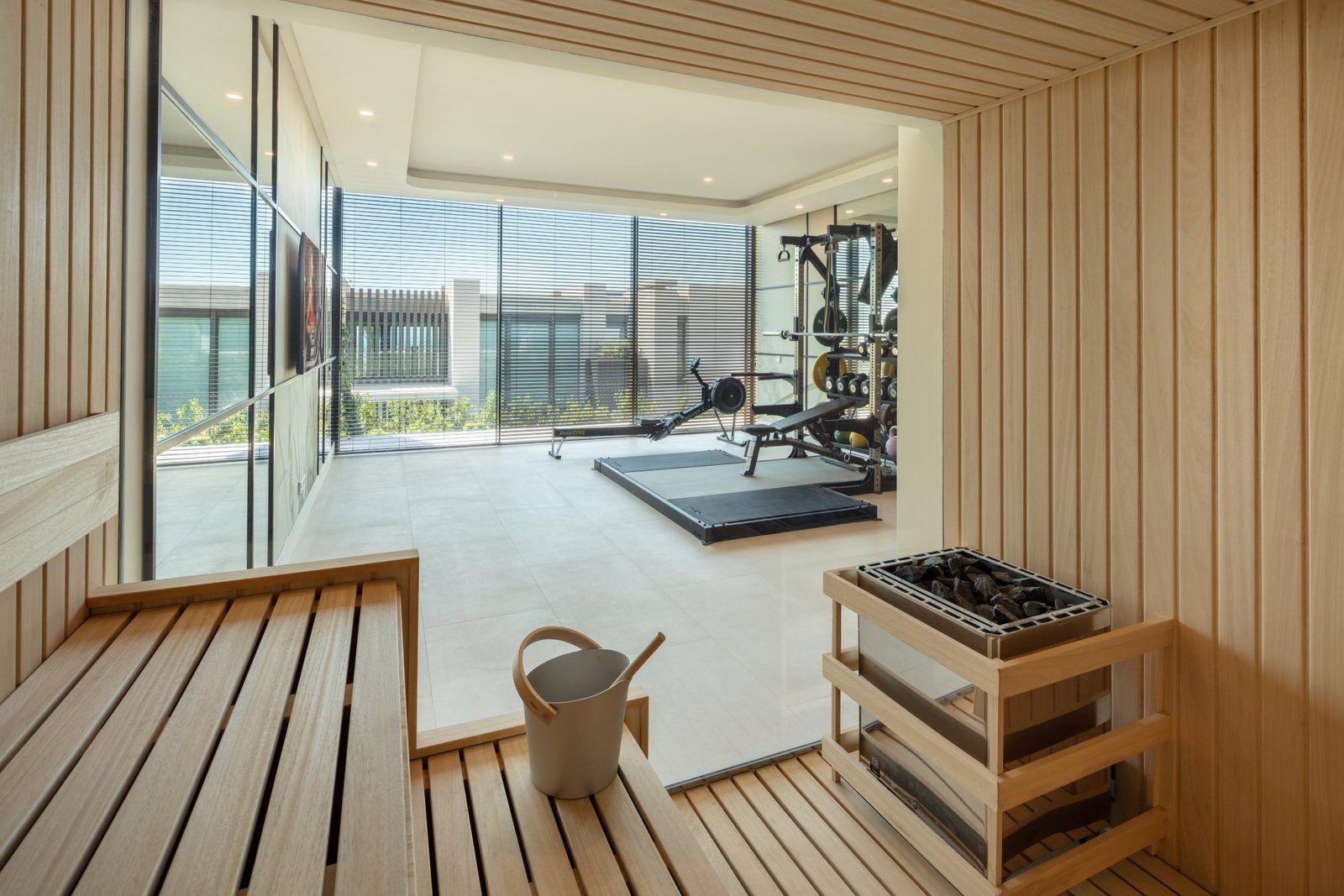 Sauna with wooden benches and adjoining home gym in a 7-bedroom villa in Málaga - The Estates