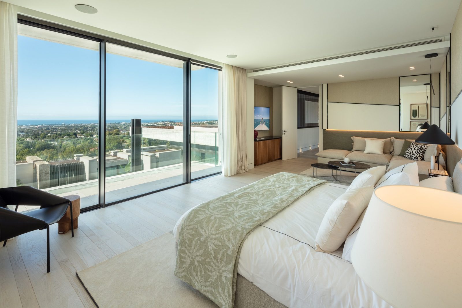 Modern bedroom and lounge with panoramic sea views of a 7-bedroom villa in Málaga - The Estates