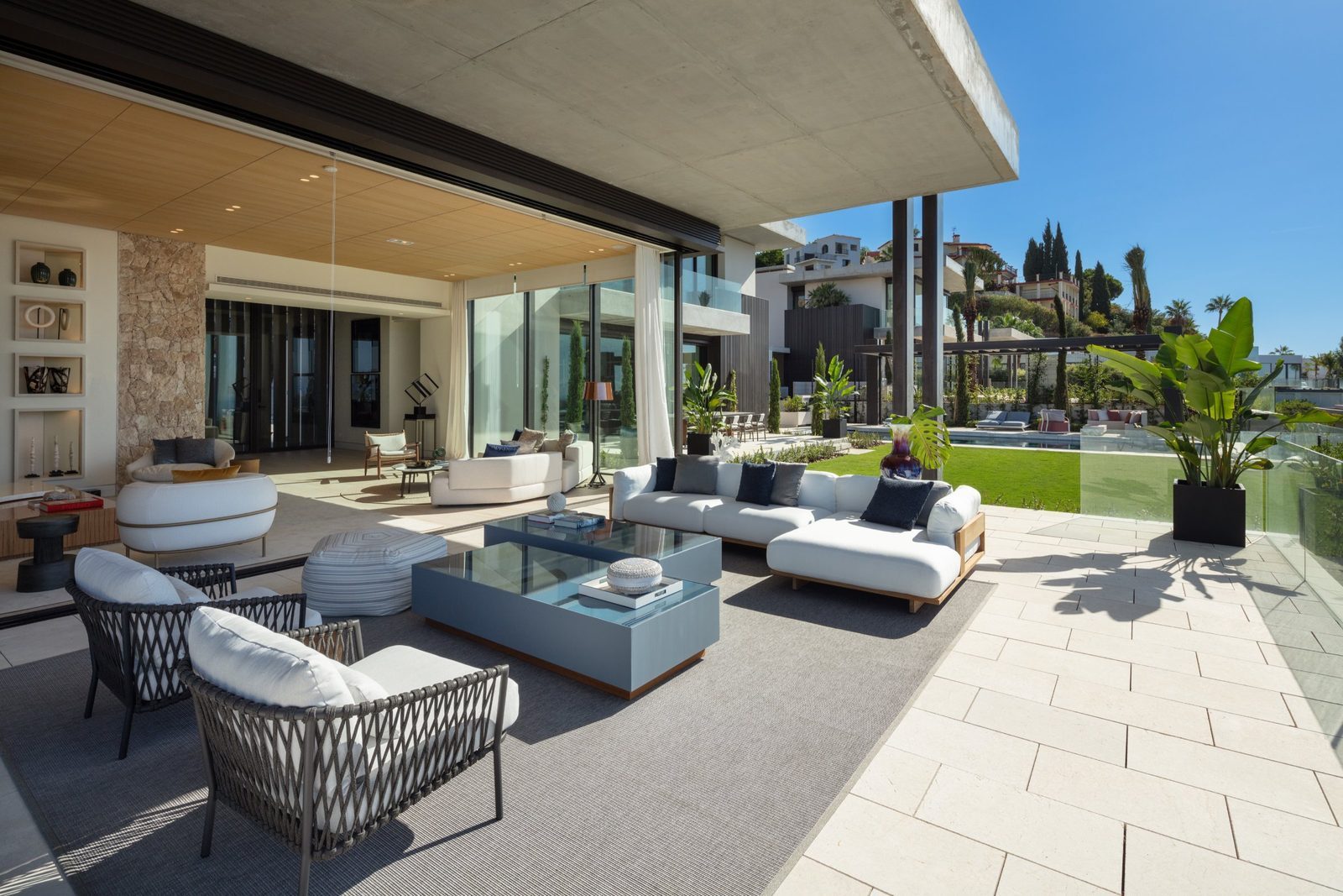 Contemporary outdoor living area with lounge seating, landscaped garden and pool of a 7-bedroom villa in Málaga - The Estates