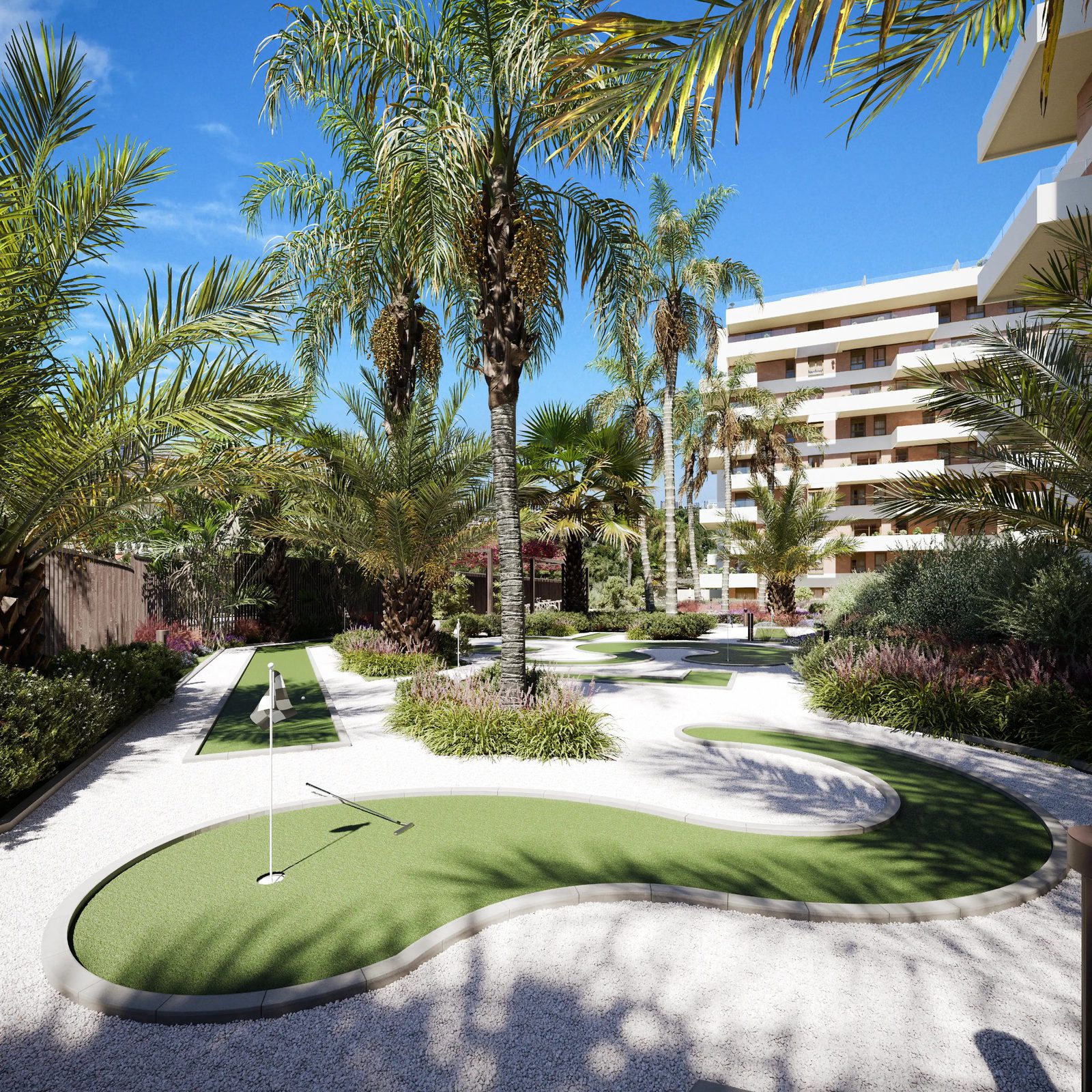 A putting green and palm trees with a modern apartment building in the background - The Estates