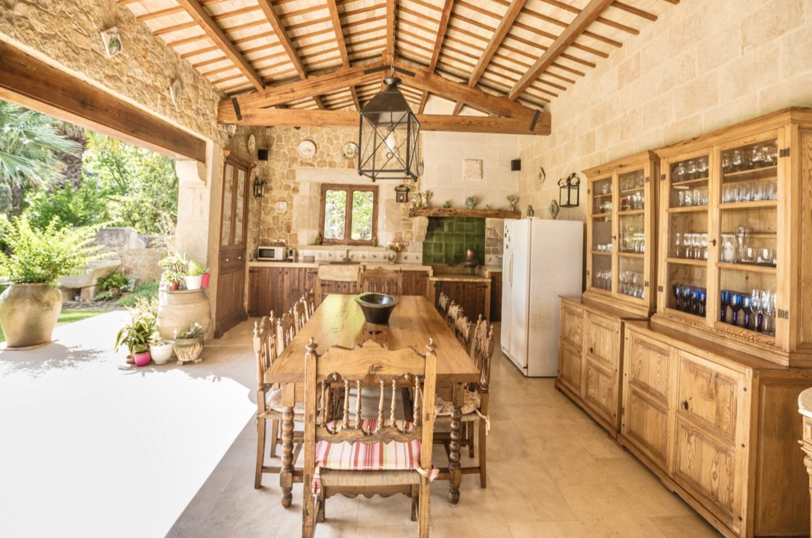 An outdoor kitchen and dining area with rustic charm in a 7-bedroom finca in Denia - The Estates