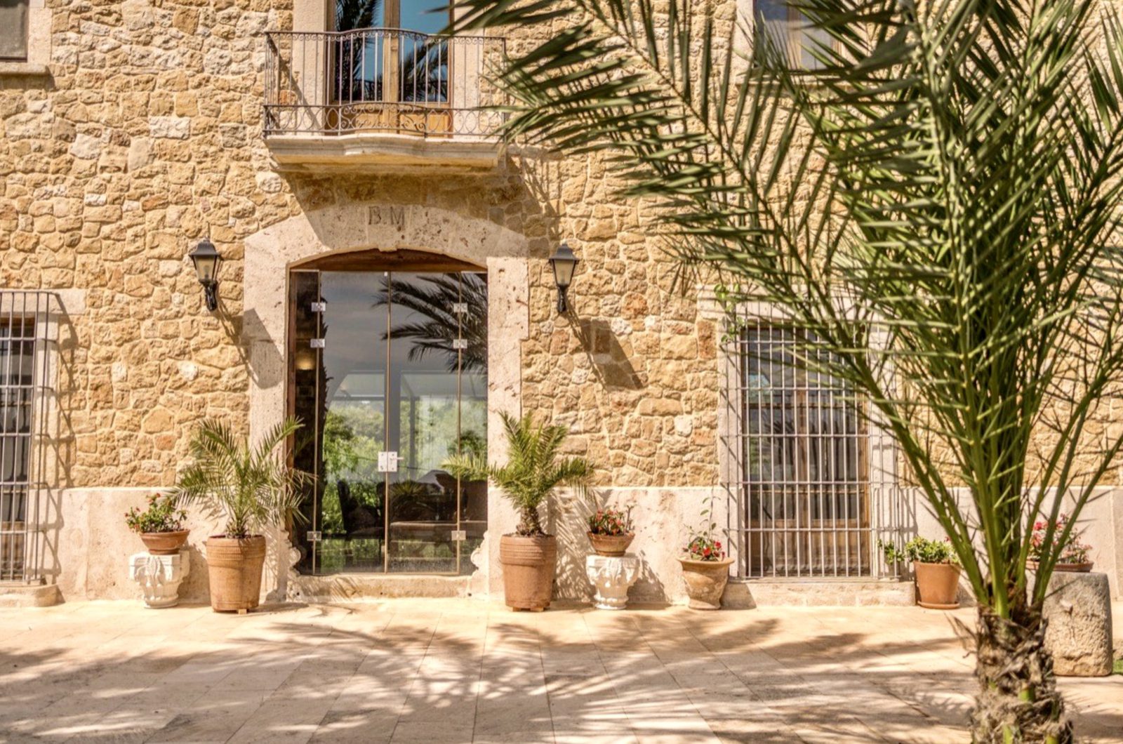 The stone facade and entrance of a 7-bedroom finca in Denia - The Estates