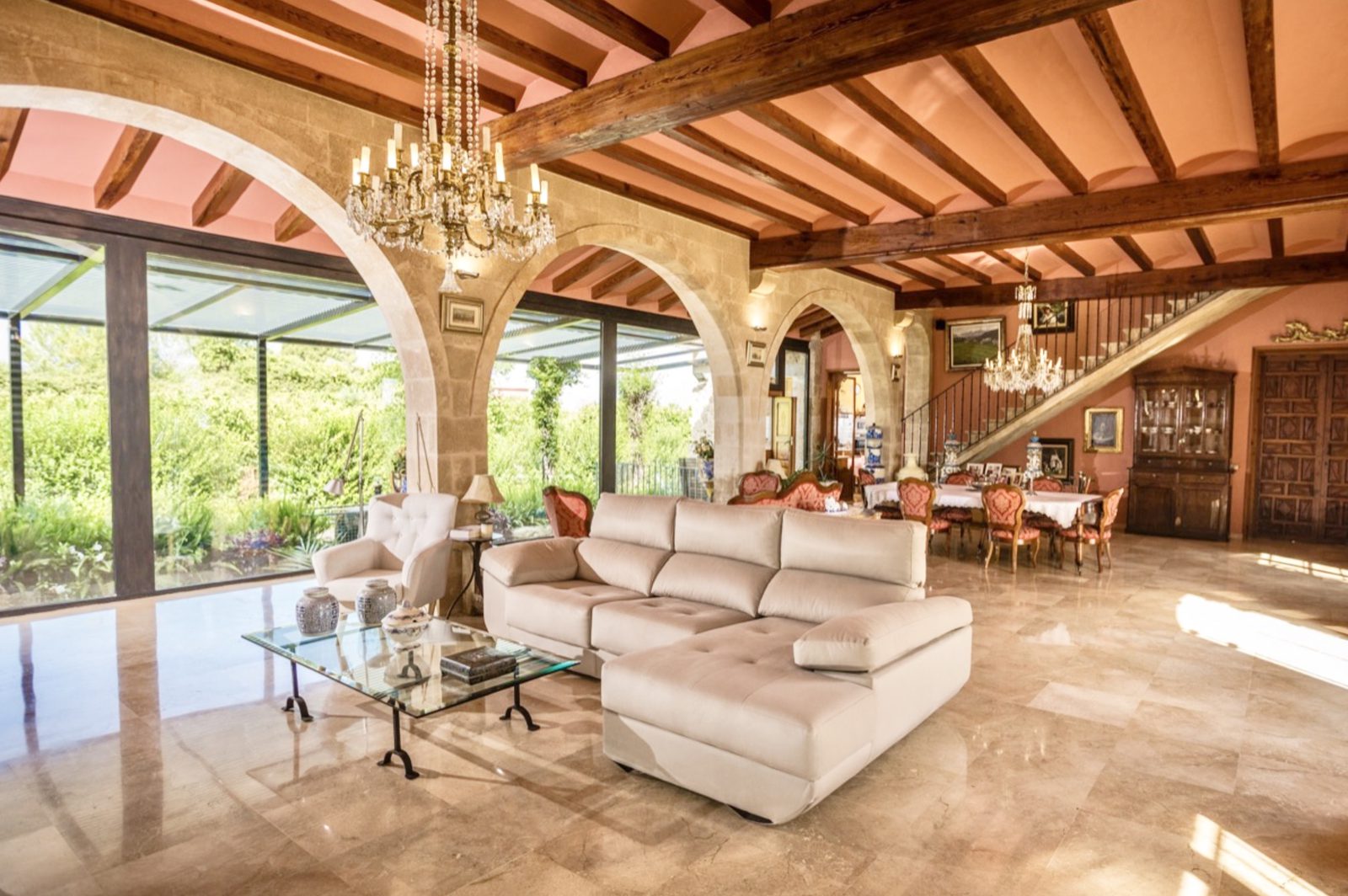 Elegant living room with exposed beams and arched doorways in a 7-bedroom finca in Denia - The Estates